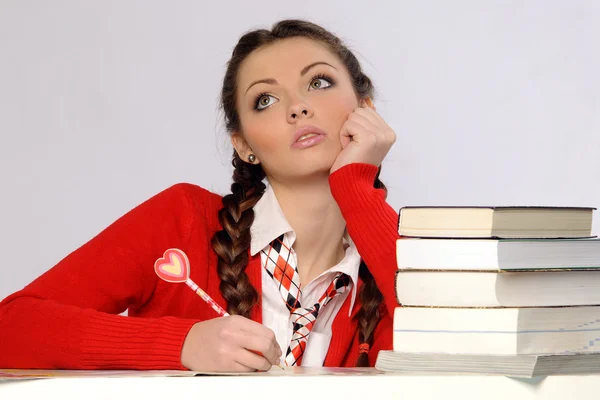 Menina da faculdade com pilha de livros — Fotografia de Stock