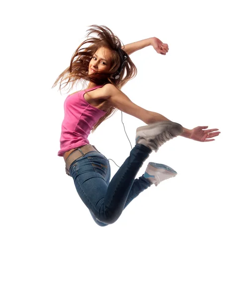 Girl in headphones jumps — Stock Photo, Image