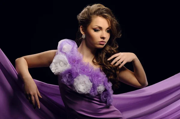 Beautiful girl in a purple dress — Stock Photo, Image