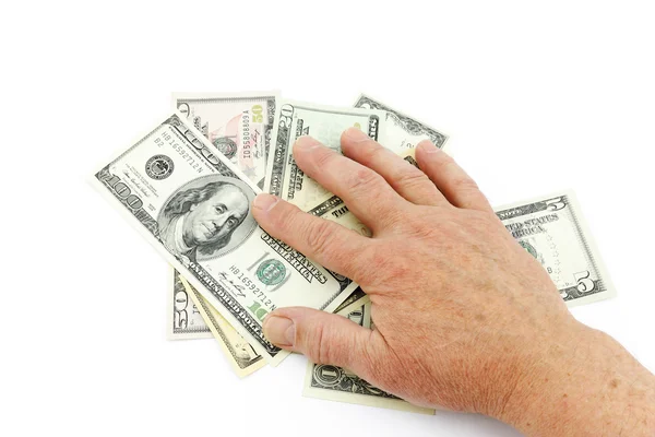 Рука на долларах — стоковое фото