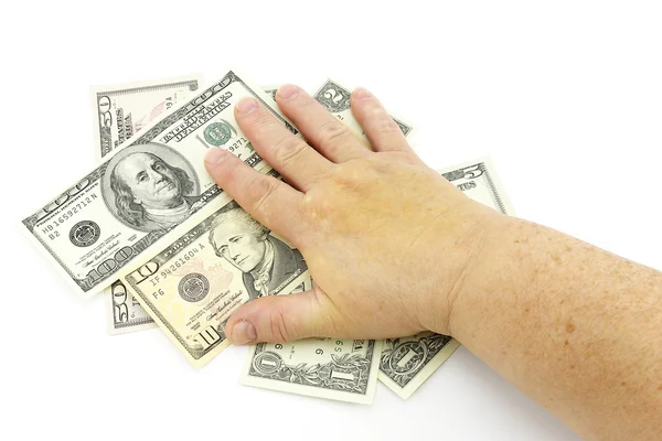 Рука на долларах — стоковое фото