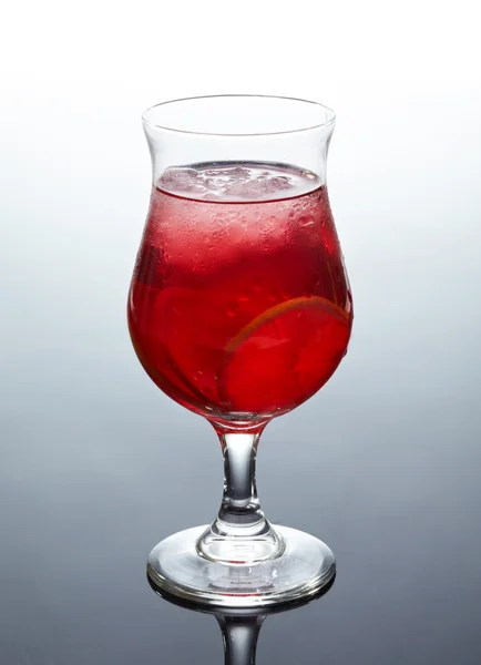 Glass of fresh red cocktail with lime and ice — Stock Photo, Image