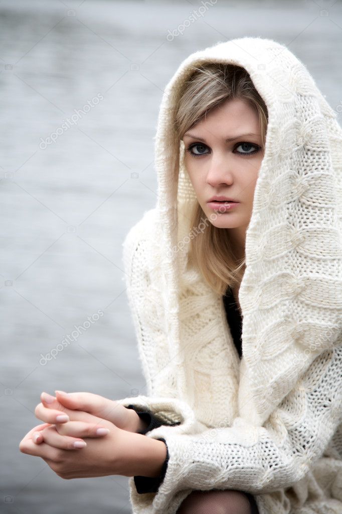 The beautiful girl in a dress with a hood