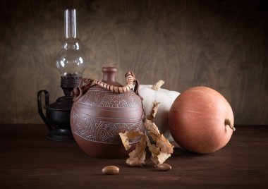 Still-life with a jug an oil lamp and pumpkins clipart