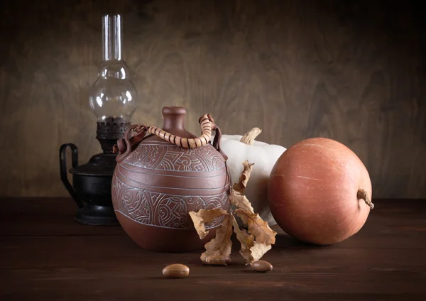 stock image Still-life with a jug an oil lamp and pumpkins