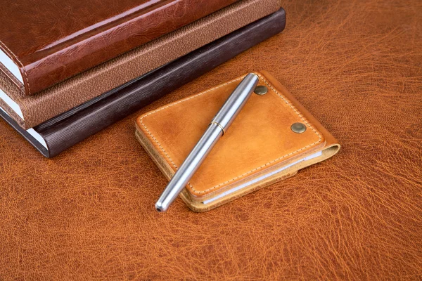 Business still-life with leather organizers and a pen — Stock Photo, Image