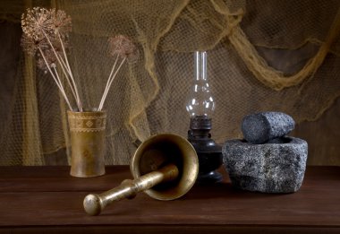 Still-life with mortars and an oil lamp clipart