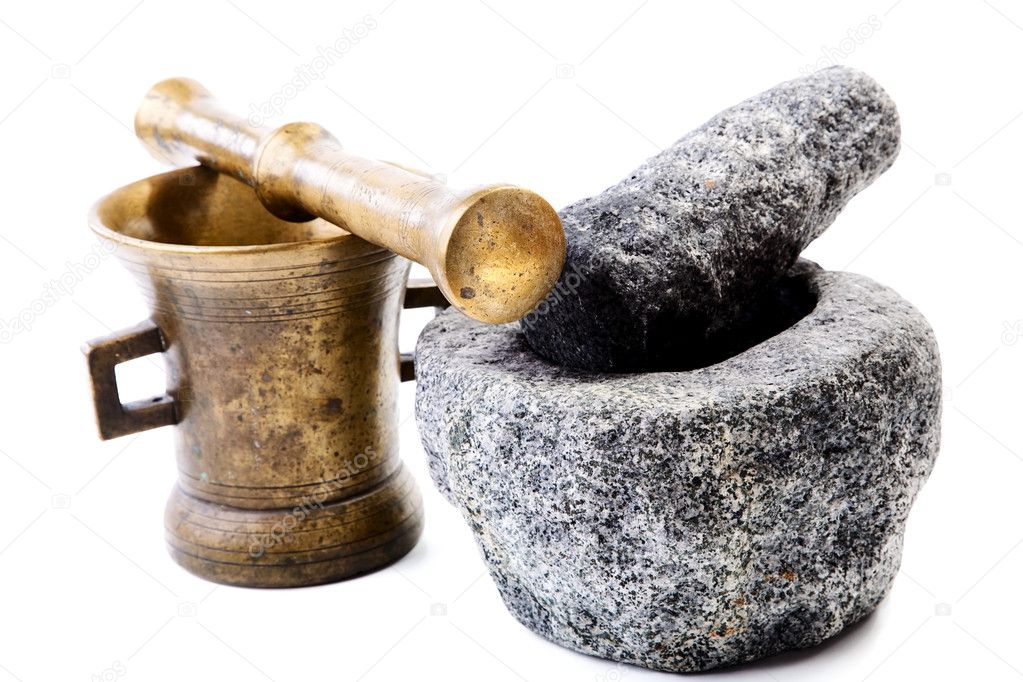 Granite and brass mortar with pestles on a white