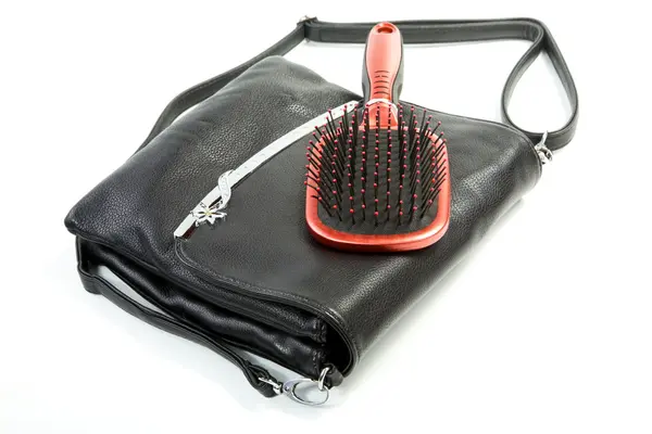 Female bag and hairbrush isolated on a white — Stock Photo, Image