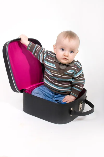 Baby sitting in a old suitcase — Stock Photo, Image