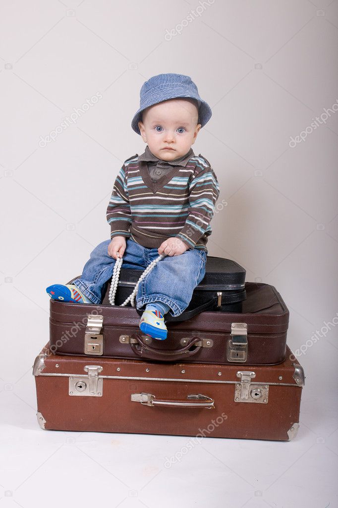 Baby sitting in a old suitcase
