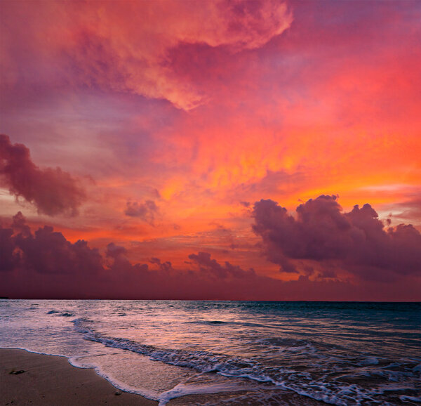 Calm ocean and beach on tropical sunrise