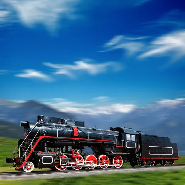 Speeding old locomotive in mountains with motion blur — Stock Photo, Image