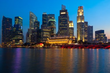 Singapore skyline and river in evening clipart