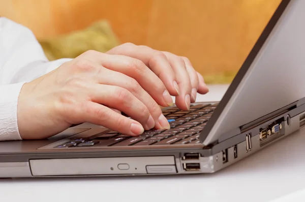 Close-up of typing on laptop keyboard of female hands — Stock Photo, Image