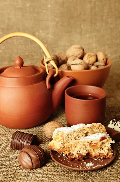 Clay teapot with sweets — Stock Photo, Image