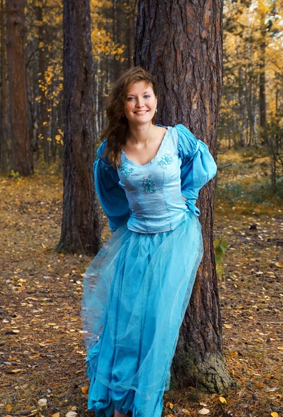 Girl in medieval dress in autumn wood