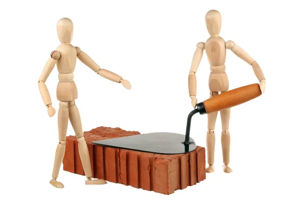Two dummy, red brick and trowel — Stock Photo, Image