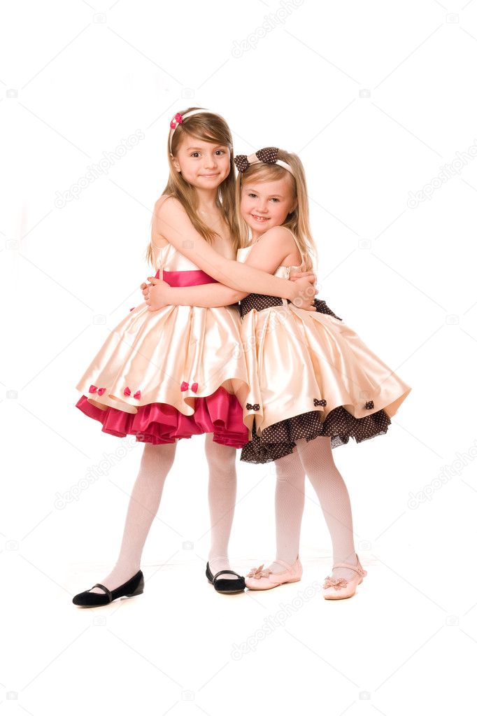 Two attractive little girls in a dress