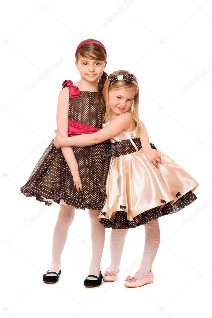 Two cute little girls in a dress. Isolated