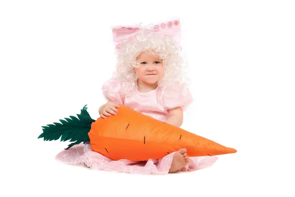 Funny baby girl plays with a carrot — Stock Photo, Image