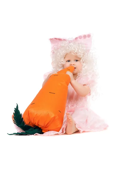 Baby girl plays with a carrot — Stock Photo, Image