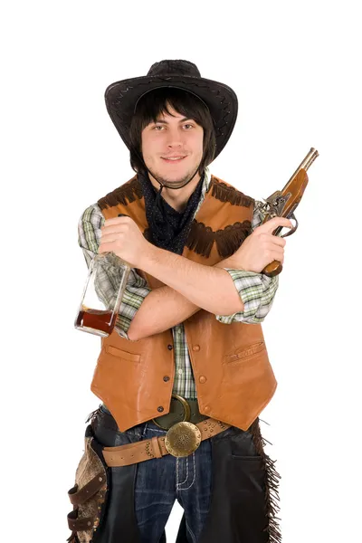 Vaquero sonriente con una botella y un arma — Foto de Stock