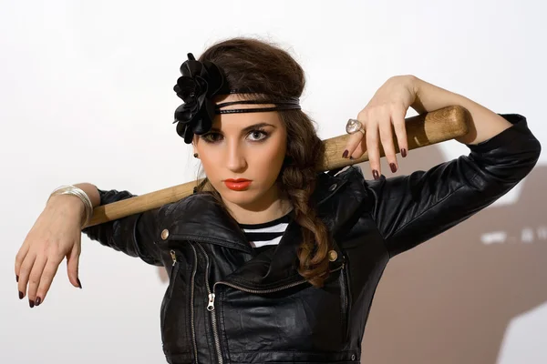 Serious young woman with a bat — Stock Photo, Image