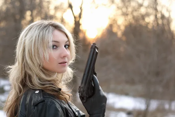 Provozierende junge Frau mit Waffe — Stockfoto