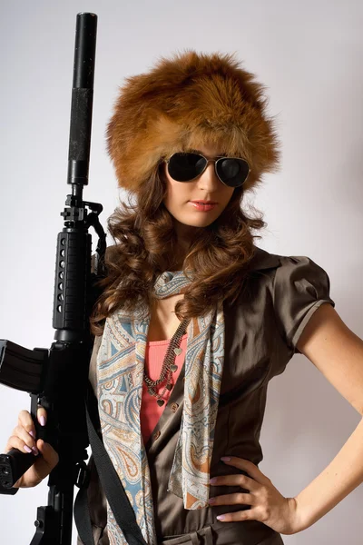 Young stylish woman with a gun — Stock Photo, Image