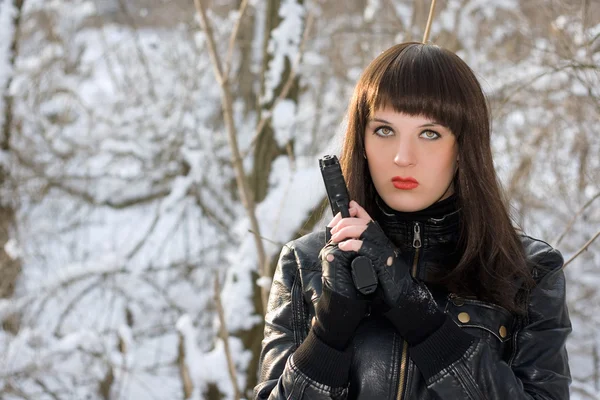 Portrait of young woman with a pistol — Stock Photo, Image