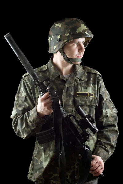 Soldier grasping a gun — Stock Photo, Image