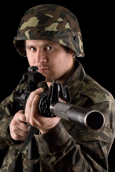 Watchful soldier aiming m16 in studio — Stock Photo, Image