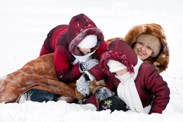 Οικογένεια χαρούμενα παίζουν σε χιόνι — Φωτογραφία Αρχείου