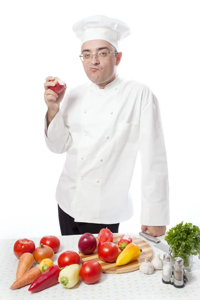 Cook eating red apple — Stock Photo, Image