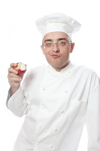 Кухар їсть червоне яблуко — стокове фото