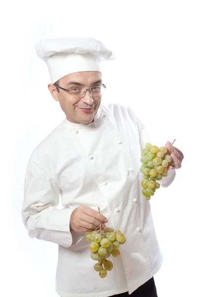 Şef aşçı ve beyaz üzüm — Stok fotoğraf