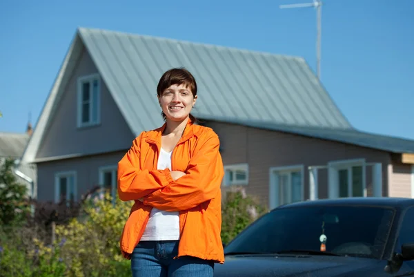 Happy woman in front of her residence — Stock Photo, Image