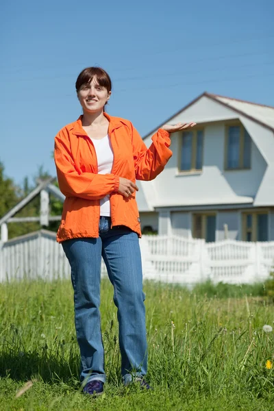 Stock image Happy woman in front of her residence