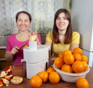 Women making fresh orange juice clipart