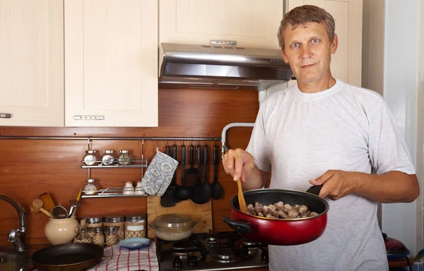 stock image Man cooks meat