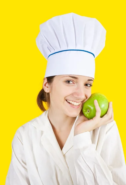 Cuoca con mela verde in mano — Foto Stock