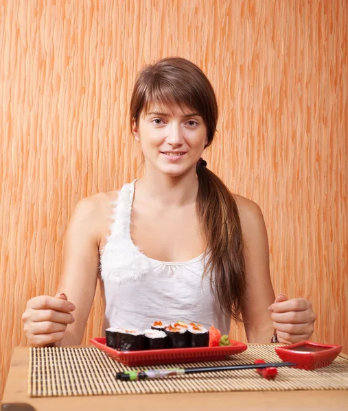 Woman eating sushi rolls — Stock Photo, Image
