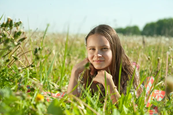 Teenager girl lying in meadow — Stock Photo, Image