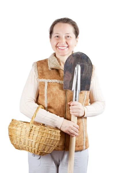 Mature woman with spade and basket — Stock Photo, Image