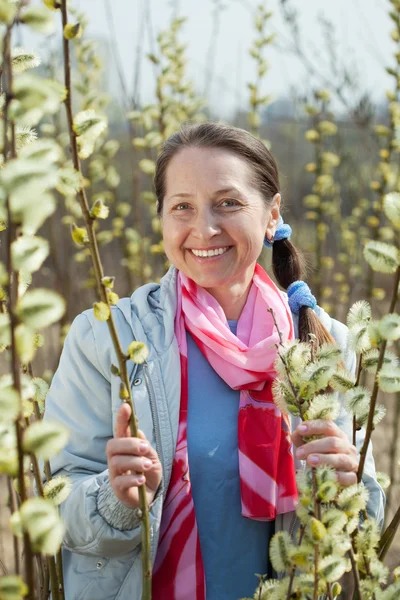 Happy mature woman against spring — Stock Photo, Image