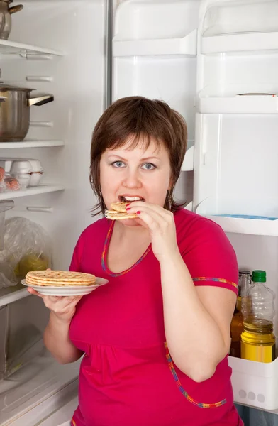 Donna che mangia focaccine dal frigo — Foto Stock
