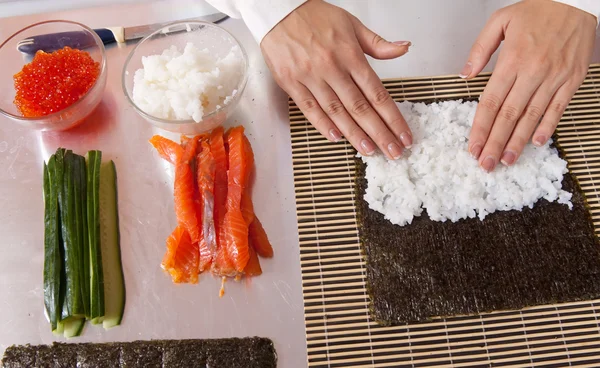 stock image Cook making sushi rolls