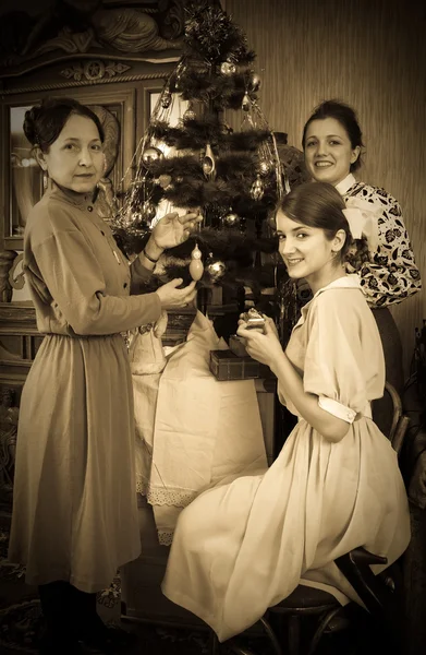 Vintage photo of daughters with mother decorating Christmas tre — Stock Photo, Image