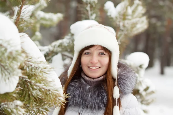Smiling woman in wintry park Stock Photo